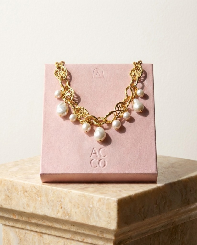 Acco pearl and gold necklace on blush branded box with embossed logotype