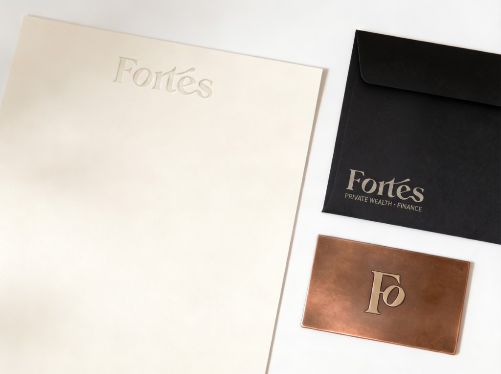 Fortés private wealth stationery: embossed letterhead, black envelope, and metal business card